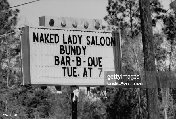 Sign of Naked Lady Saloon celebrating the execution of serial killer Ted Bundy.