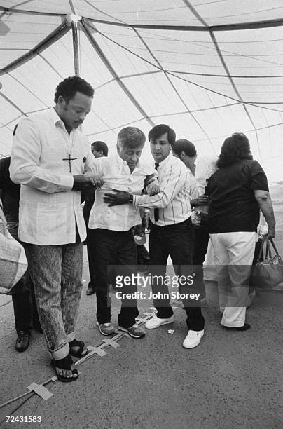 Ceasar Chavez's during fast on behalf of the UFW during boycott of the grape growers, with Rev. Jesse Jackson and his son Fernando Chavez.