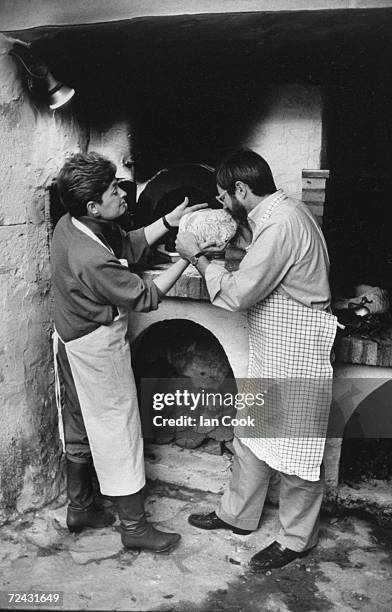 International Herald Tribune editor Walter Wells with wife Patricia, food critic, at French provincial home where they bake bread in brick oven.