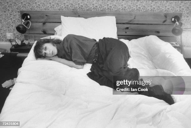 Ballerina Jolinda Menendez mourning the death of her ex-husband, ballet dancer, Patrick Bissell as she sadly lies on her bed .