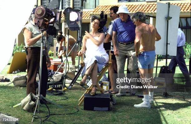 Television crew surrounding Isabella Rossellini during filming of Lancome advertisement.