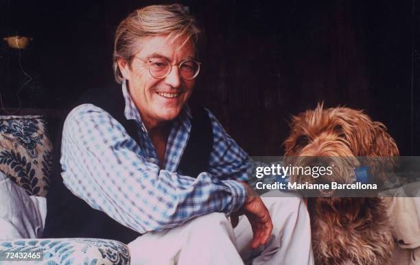 Peter Mayle, author of A DOG'S LIFE, sitting with Griffon Korthals dog at home.