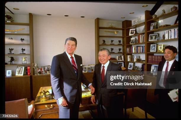 Former US President Ronald Reagan standing in his new Century City office with Japanese PM Noboru Takeshita.