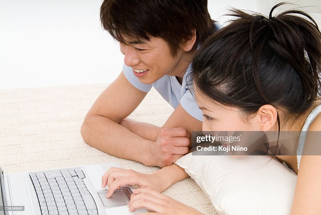 Young couple using laptop computer