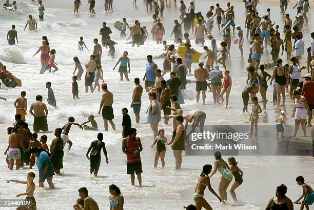 Beachgoers play in the Atlantic Ocean surf August 30, 2003 in Ocean City, Maryland. The Labor Day weekend marks the unofficial end of summer.