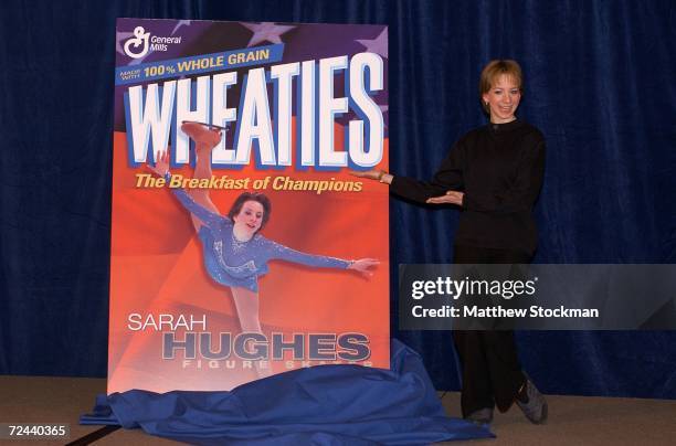 Olympic gold medal figure skating champion, Sarah Hughes, unveils the latest Wheaties box featuring her likeness at a press conference in Salt Lake...