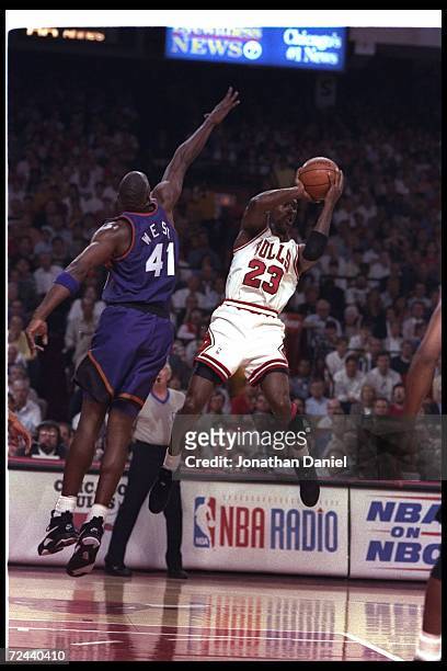 Guard Michael Jordan of the Chicago Bulls goes up for two during Game Five of the NBA finals against the Phoenix Suns at the United Center in...