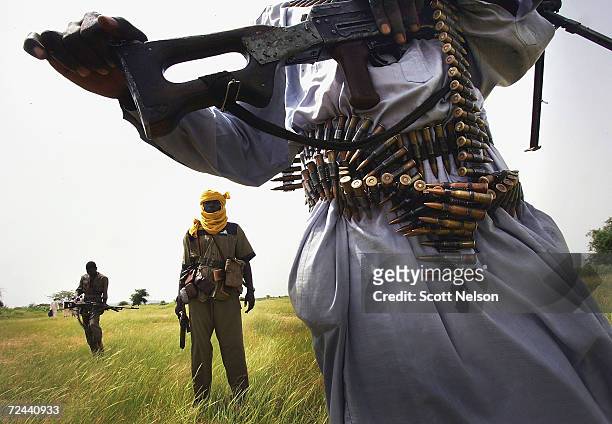 Heavily armed rebel Sudanese Justice and Equality Movement fighters patrol looking for Janjaweed militiamen near their base in the Darfur region of...