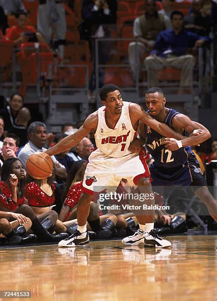 Point guard Rod Strickland of the Miami Heat posts up guard Chris Whitney of the Washington Wizards during the NBA game at American Airlines Arena in...