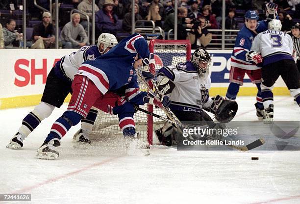 Goalie Jamie Storr of the Los Angeles Kings blocks the goal as Tim Taylor of the New York Rangers moves for the puck at the Staples Center in Los...