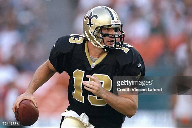 Quarterback Kerry Collins of the New Orleans Saints runs with the ball during a game against the Miami Dolphins at the Pro Player Stadium in Miami,...