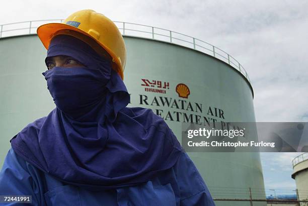 Worker is pictured at oil and gas processing facilities at Seria, September 7, 2004 in Brunei. Brunei produces around 218,000 barrels a day of crude...
