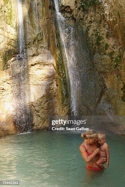 Mother and her son bathe at a waterfall near Nydri August 10, 2003 on Lefkada Island in Greece. Jackie Onassis, while spending time on the nearby...