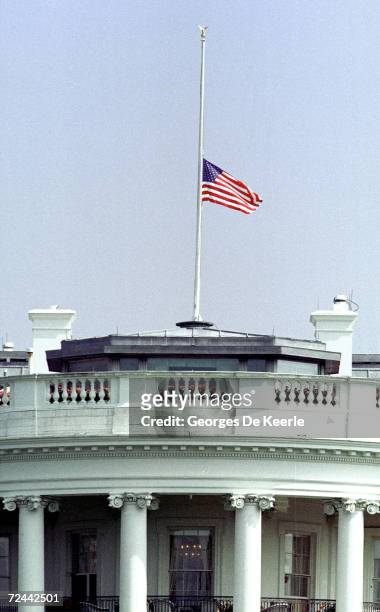 The United States flag flies at half staff over the White House July 23,1999 in Washington, DC. President Clinton ordered the US flag lowered to...