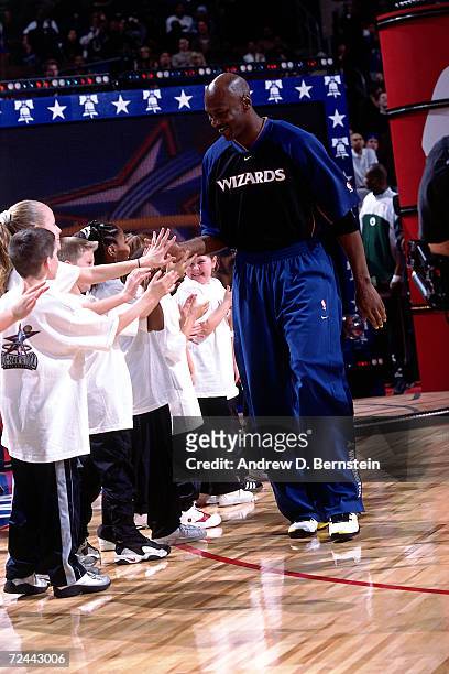Michael Jordan of the Washington Wizards greets some young fans during player intros before the 2002 NBA All Star Game at the First Union Center in...
