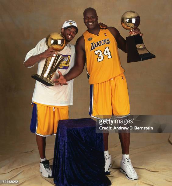 Kobe Bryant and Shaquille O''Neal#34 of the Los Angeles Lakers pose for a portrait with the Championship Trophy, and the MVP Trophy respectivly after...