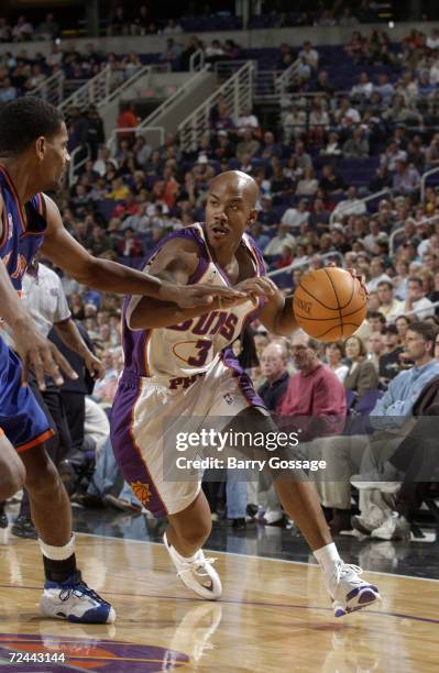 Point guard Stephon Marbury of the Phoenix Suns drives past forward Kurt Thomas of the New York Knicks during the NBA game at America West Arena in...