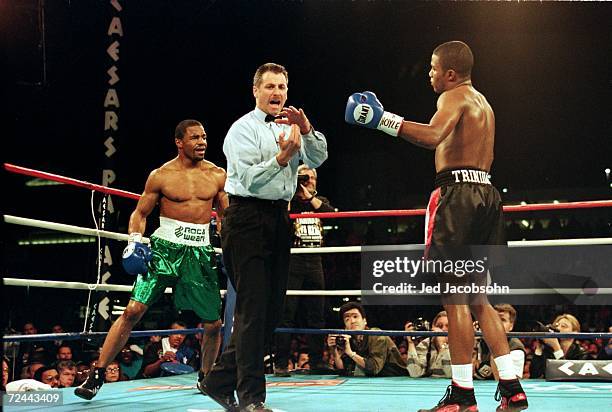 Referee Mitch Halpern gives a signal to Felix Trinidad during the fight against David Reid at Caesar Palace in Las Vegas, Nevada. Trinidad defeated...