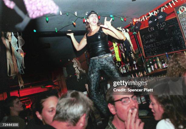 Women dance on the bar at Coyote Ugly August 7, 2000 in New York City. The rowdy East Village bar is the recent subject of a Hollywood movie.