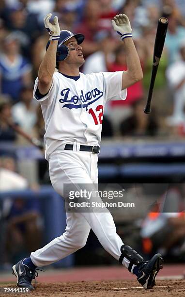 Steve Finley of the Los Angeles Dodgers drops his bat after hitting a ninth inning walk off grand slam home run against the San Francisco Giants on...