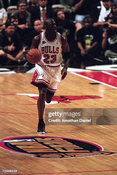 Michael Jordan of the Chicago Bulls dribbles the ball down the court during the NBA Final game against the Utah Jazz at the United Center in Chicago,...