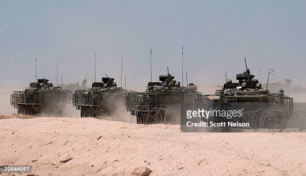 Column of U.S. Army Stryker light amored vehicles on reconnaissance operations push out from forward operating base Duke Duke April 14, 2004 about 12...