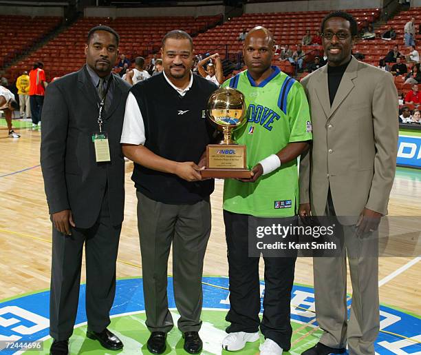 Jeff Myers of the Greenville Groove receives his Defensive Player of the Year Award at the game against the Columbus Riverdragons also pictured are...