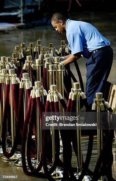 Capitol maintnance worker set up velvet rope during the preparation of the U.S. Capitol Building's rotunda for the former President Ronald Reagan's...