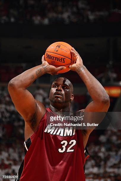 Shaquille O'Neal of the Miami Heat prepares to shoot a free throw during a game against the Chicago Bulls on opening night at American Airlines Arena...