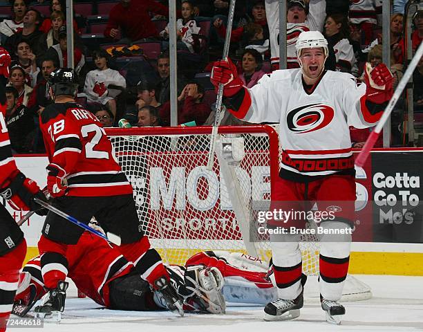 Justin Williams of the Carolina Hurricanes celebrates a goal by teammate Rod Brind'Amour in the third period against Martin Brodeur of the New Jersey...