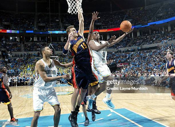 Chris Paul of the New Orleans/Oklahoma City Hornets attempts a layup against Andris Biedris of the Golden State Warriors on November 7, 2006 at the...