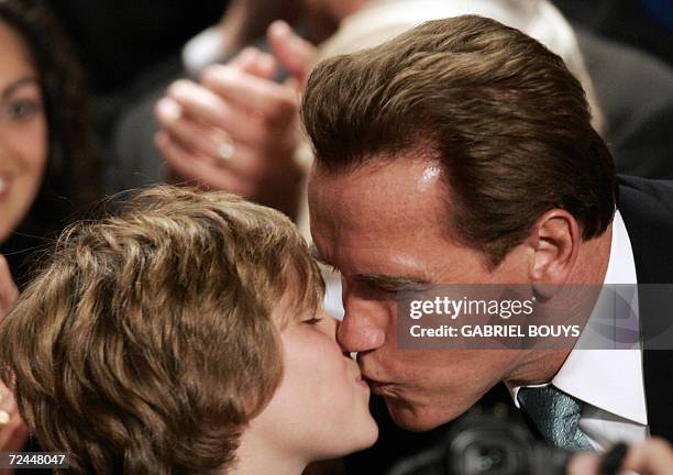 Beverly Hills, UNITED STATES: California Governor Arnold Schwarzenegger celebrates with his son Christopher after being re-elected in the midterm...