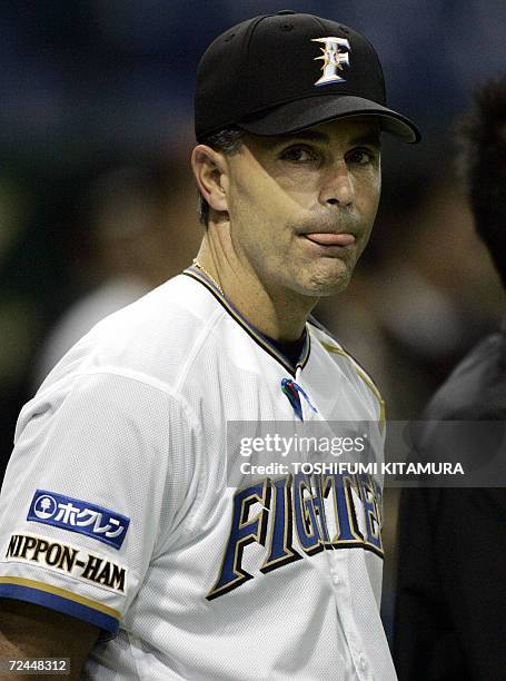 Japanese baseball team Nippon Ham Fighters head coach Trey Hillman from the US watches his players during their official training of the Konami Cup...