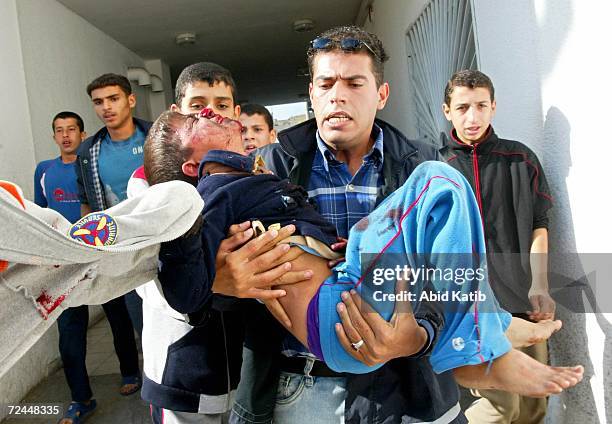 Wounded Palestinian boy is rushed in to Kamal Odwan hospital after Israeli tanks fired on homes November 8, 2006 in the town of Beit Hanoun in the...