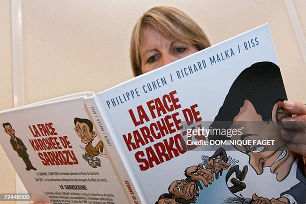 Woman reads a comic book, "La Face Karchee de Sarkozy" by Philippe Cohen, Richard Malka and Riss, which traces the life and times of French...