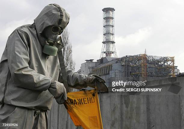 Rescue worker sets flag signalling radioactivity in front of Chernobyl nuclear power plant during a drill organized by Ukraine's Emergency Ministry...