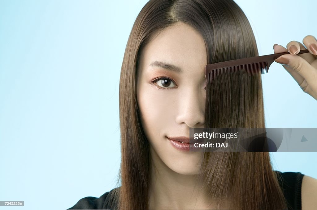 Young Woman Combing Hair