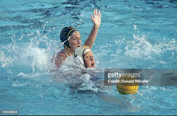 Jennifer Durley of USC tries to control the ball as Lana Kraus of Cal State slaps during the NCAA Womens Water Polo at McDonalds Swim Center at USC...