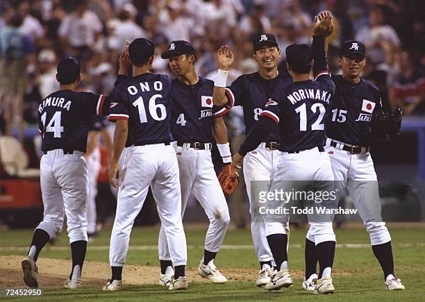 The Japanese team celebrates during the USA v Japan baseball game at Atlanta-Fulton County Stadium at the 1996 Centennial Olympic Games in Atlanta,...