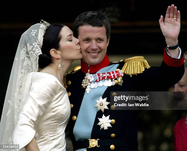 Danish Crown Prince Frederik and his bride Princess Mary kiss as the Royal couple appear on the balcony of Christian VII's Palace after their wedding...