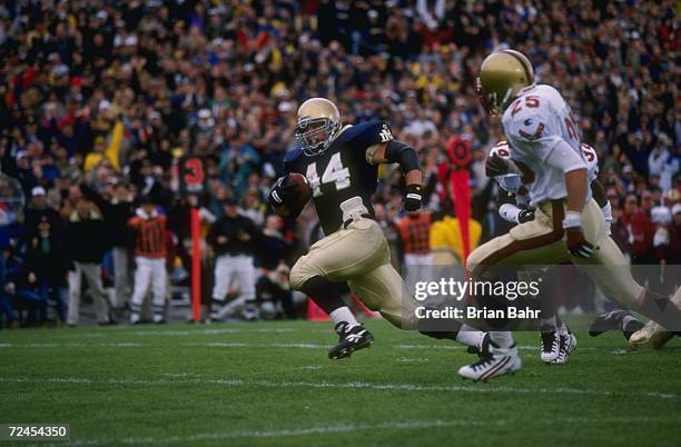 Fullback Marc Edwards of the Notre Dame Fighting Irish looks up field as he makes a cut to the inside in attempts to out run a defender from the...