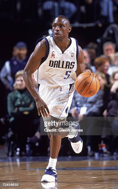 Point guard Avery Johnson of the Dallas Mavericks dribbles the ball during the NBA game against the Miami Heat at the American Airlines Arena in...