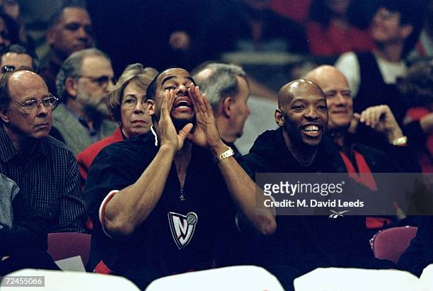 Jayson Williams and Sam Cassell of the New Jersey Nets cheer on of the St John''s Red Storm during the game against the Duke Blue Devils at the...