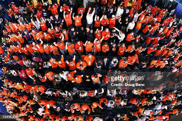 Sea orange erupts as the Illinois Fighting Illini score a three pointer to open the game against the Arizona Wildcats in the Chicago Regional Final...