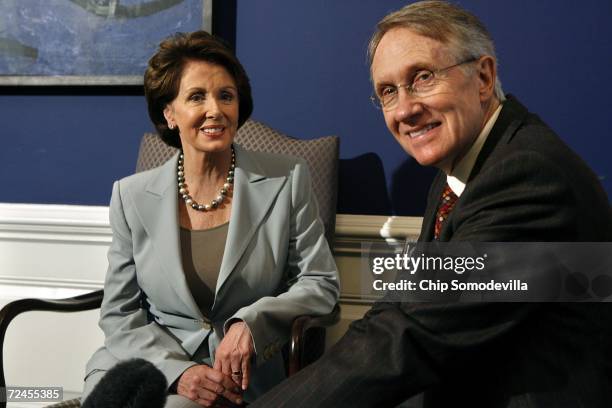 House of Representatives Democratic Leader Nancy Pelosi and Senate Democratic Leader Harry Reid pose for photographs in Pelosi's office at the US...