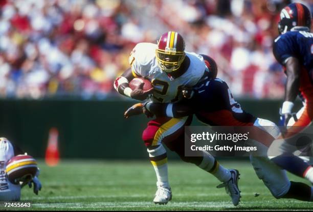 Running back Terry Allen of the Washington Redskins in action against linebacker John Mobley of the Denver Broncos during the game at the Jack Kent...
