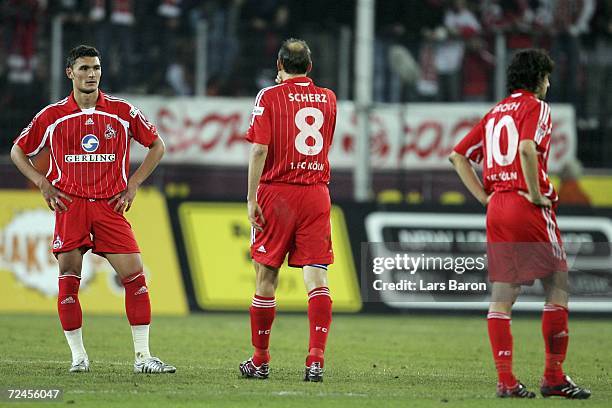 Aleksandar Mitreski, Matthias Scherz and Thomas Broich of Cologne look dejected after loosing the Second Bundesliga match between 1. FC Cologne and...