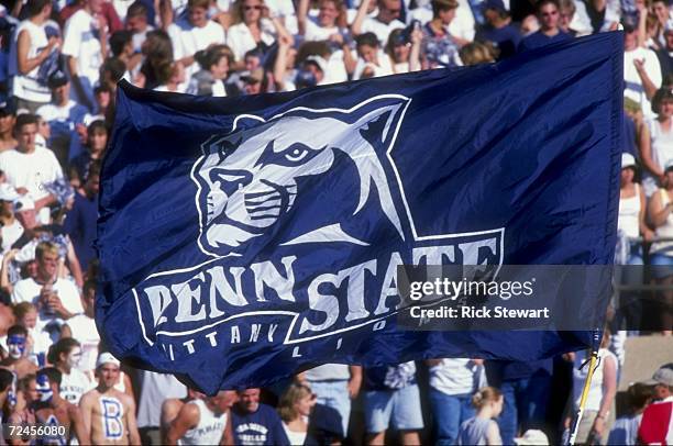 Penn State Nittany Lion fans hoist a flag up in the air during a game against the Southern Mississippi State Golden Eagles at the Beaver Stadium in...