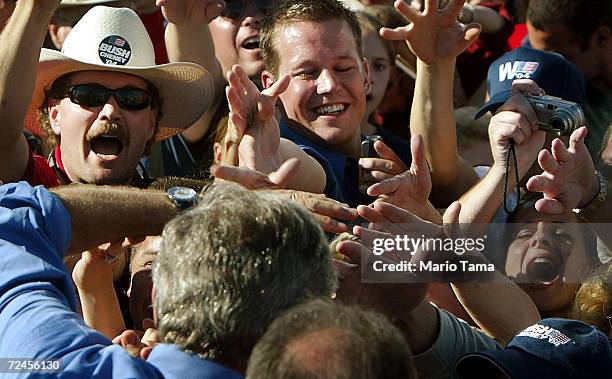 President George W. Bush greets supporters at a Victory 2004 rally October 9, 2004 in Chanhassen, Minnesota. Bush met Democratic presidential...