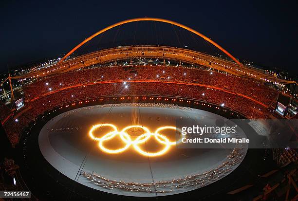 The Olympic rings are seen as drummers perform during the opening ceremony of the Athens 2004 Summer Olympic Games on August 13, 2004 at the Sports...